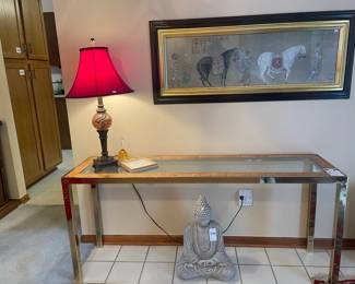 Chrome and wood console table, lamps, Cement Buddha Statue