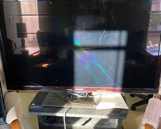 46”  flat screen television with Remote on a TV Stand.  Also have 2 24” TVs’