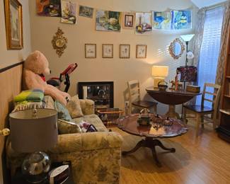 wood coffee table with carved design (it's beautiful), original artwork is featured on the wall
