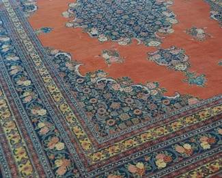 Persian Mashad Carpet!! Handmade Persian wool Mashad carpet with a central blue medallion againest a orange field, blue spandrels and borders 8'10 x 13' 1/2" Circa 1920