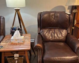 tripod lamp, leather recliner, table with basket