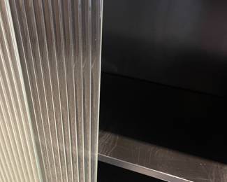 Detail pic, Glass doors 
MCM STEELCASE Rectified Black metal and Chrome industrial cabinets with vertical fluted sliding glass doors. 