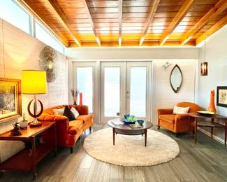 Round Off-White Soft Shag rug with an Orange Panne Velvet Parlor Sofa and Coordinating Orange Occasional chair surrounded by Mid Century decor and  Stellar, 1 owner Danish Mid Century Teak Furniture. 