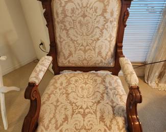 Ornate carved wood and fabric chair