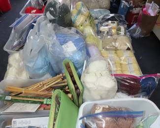 Bags of yarn, knitting needles, knitting patterns.