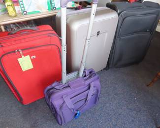 New hard shell suitcase and three soft side suitcases.