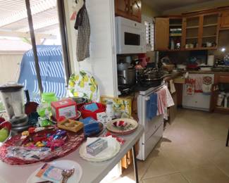 KitchenAid blender, Salad Shredder, large decorative red glass dish with sun catchers, pie plates, new flatware and measuring spoons.