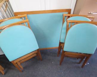 Folding wooden games table with 4 folding chairs. Very nice.