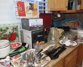 Boxed stemware, decorative platters, utensils.New boxed stemware, decorative plates, Cutco knives.