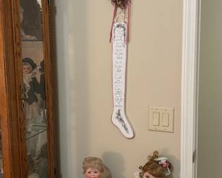 Probably 50 dolls in the doll collection and a doll caninet