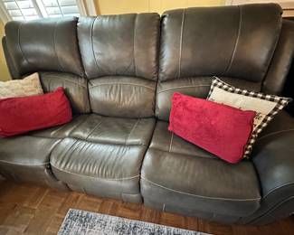 Leather upholstered sofa with electrically reclining end seats.