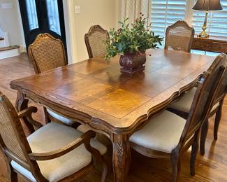 Table (with pads) with 8 cane back chairs (71” by 45” w/o leaves