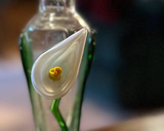 Art glass vase with applied lily and greenery.
