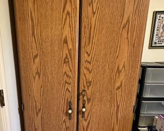 Oak finish tall storage cabinet