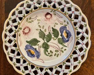 Hand painter wall plate with lattice weave rim made in Portugal.