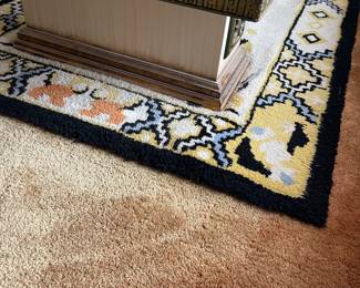 This is a hook rug,  the coffee tabletop was filled with stuff, but the coffee table has the 1970's viened smoked glass in panels and it is large and I bet heavy.   