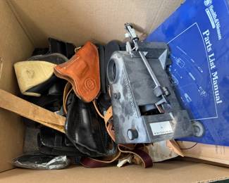 Gun holsters, manuals books and magazines, and other gun parts 
