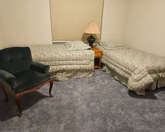 Twin mattress sets on metal frame. Lovely lamp and bedroom chair
