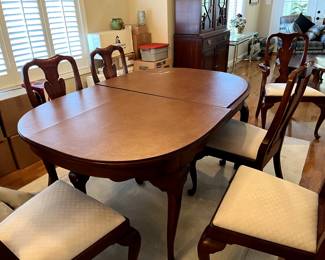 Beautiful and timeless...this dining room set as 2 captain chairs and 6 regular chairs...pads for the table included. It has THREE leaves, also with pads.  Henkel-Harris Wild Black CHerry...gorgeous!. Seat cushions in cream and spotless!