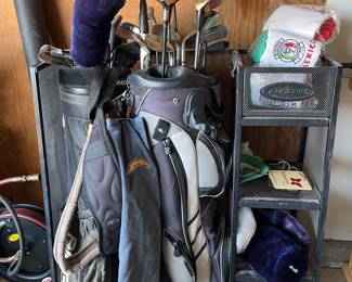 2 sets of golf clubs and a golf club holder