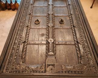 Antique Painted Door Table 35" X 72" X 30" (Possible purchased from Art of Old India, Inc.)  Two different sets of legs that screw into the table.  Can be used as an eating table or a coffee table.  Has large piece of glass that covers the table. 