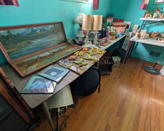 table with paintings by C Aspers a local colorado artist