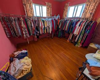 This room has a full closet full of pants and both of these racks full of Vintage clothing. 