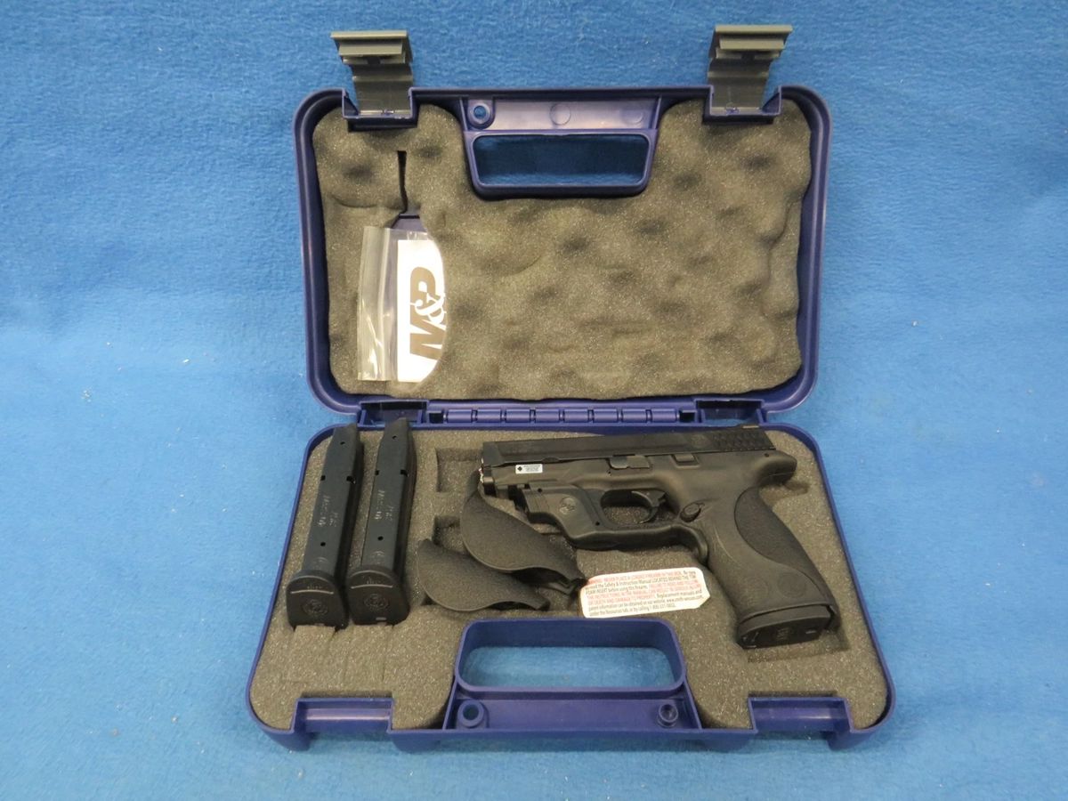 Lot 9. Smith & Wesson M & P 40 semi-auto. Ser. No. HLR3800. Includes case, manual, three magazines, two extra grips, and a Crimson Trace sight.