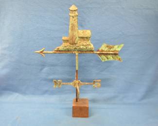 Lot 316. Lighthouse-themed metal weathervane with a heavy display base. 27" tall with base.