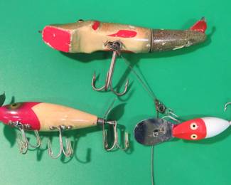 Lot 70. Three fishing lures: Robert's 5 1/8" Mud Puppy with a broken wire leader, South Bend 2 7/8" wooden Nip-I-Deedee, Heddon 1 3/4" Tiny Deep Dive Runt
