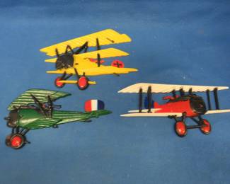 Lot 369. Metal wall hanging WW1 planes. One is marked 1975.