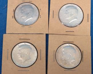 Lot 38. Four 90% silver 1964 Kennedy half dollars