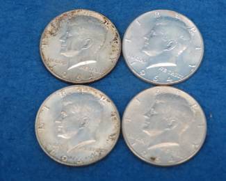 Lot 181. Four silver 1964 Kennedy Half Dollars