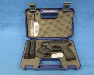 Lot 9. Smith & Wesson M & P 40 semi-auto. Ser. No. HLR3800. Includes case, manual, three magazines, two extra grips, and a Crimson Trace sight.