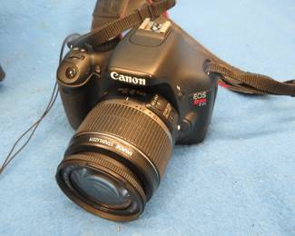 Lot 199. Canon EOS Rebel T2i camera, extra lenses, manual, and supplies. Untested.