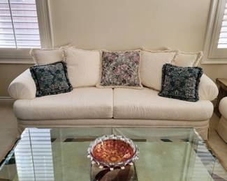 Comfy sofa, glass top table, cranberry art glass bowl