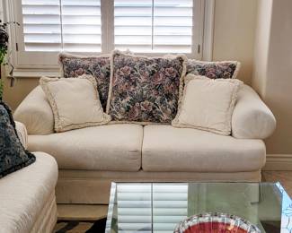 Comfy love seat, glass top table, cranberry art glass bowl