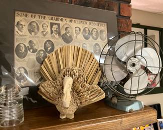 Basement -reunion committee picture, vintage fan, carved turkey, glass