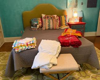 Upholstered queen headboard, bohemian style bedding, vanity stool