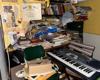 books hiding, as well as a nice looking keyboard and cool old office chair on a swivel