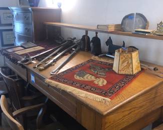 oak post office desk, oriental rug, swords