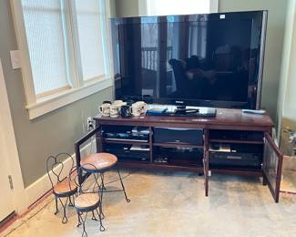 Small ice cream parlor chairs and table, TV cabinet with Samsung Blue Ray player, OnKyo DV-CP704, DVD player, Onkyo AV Receiver HT-R550, Onkyo Speakers (4), Samsung TV