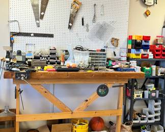 Lots of hand tools, metal shelf full of nails, grinder and more