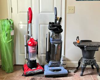 2 green bag chairs, Dirt Devil and Hoover Windtunnel vacuum cleaners, wood stove "Tenn Stove Works"