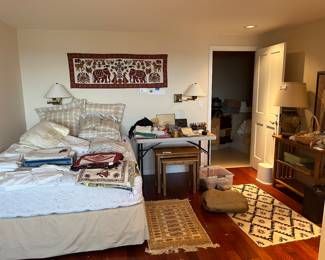 Overview of bedding, furniture and other items for sale during in-person shopping hours.