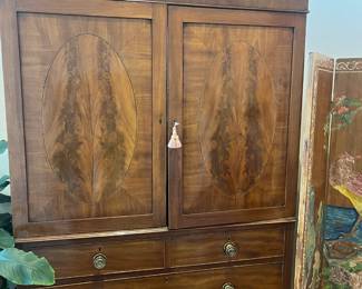 $1400. Antique flame mahogany armoire. Four drawers below, hanging rod behind the doors. 50"w x 21"d x 88"h. Available for online purchase beginning Wednesday, January 22 starting at 7pm. All online purchases are final. Please see details on how to do it in our sale description.
