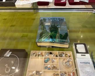 The book in the back is an extensive stamp collection - not totally organized, but MANY stamps.