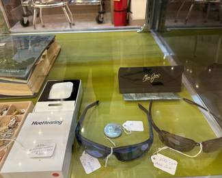 We have two pair of Maui Jim Sunglasses.  The Ray Ban case in the back is case only.
