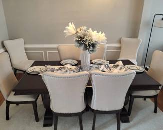 All wood, practically new dining room table. Can be extended to fit 8 people. All chairs are cloth/linen with brass studs. Smoke free and pet free home.