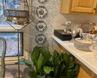 Antique brass bird cage, copper pot with plant